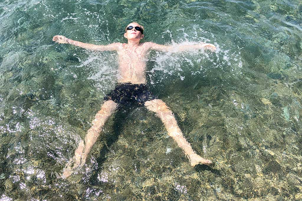 the-child-swims-in-the-sea al mare in sicurezza